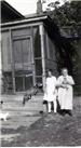 Edith Kiichli and Mrs. Wales at back door of Ingersoll house